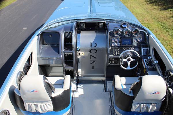 Slide: The Image of 2006 Donzi 43 ZR boat cockpit with steering wheel and control panel. - 28