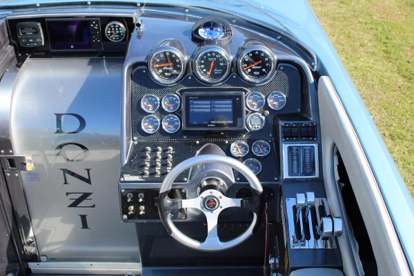 Slide: The Image of 2006 Donzi 43 ZR boat dashboard with gauges, steering wheel, and control panel. - 29