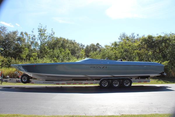Slide: The Image of 2006 Donzi 43 ZR speedboat on a trailer, parked on a road with trees in the background. - 4