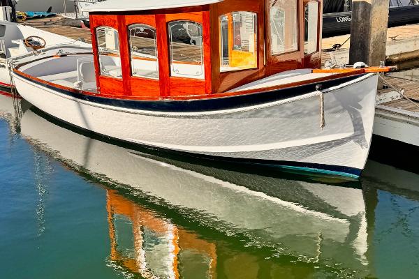 Slide: The Image of 1984 Duffy 20 Hardtop Diesel boat docked, reflecting on calm water. - 0