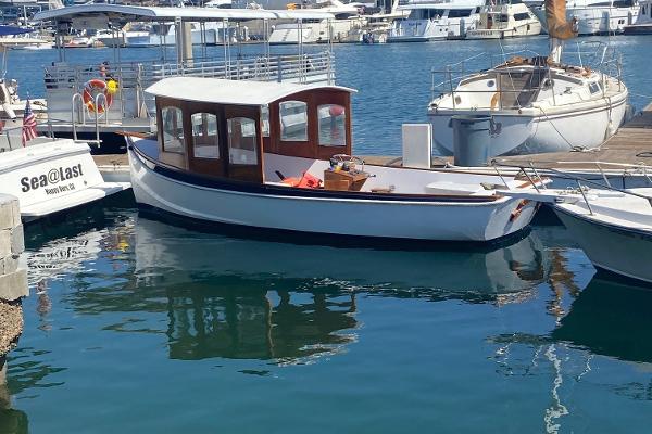 Slide: The Image of 1984 Duffy 20 Hardtop Diesel boat docked in a marina. - 1