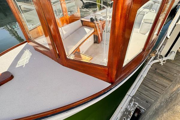 Slide: The Image of 1984 Duffy 20 Hardtop Diesel boat with wooden cabin docked at marina. - 2