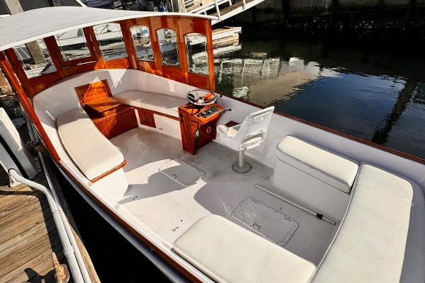 Slide: The Image of 1984 Duffy 20 Hardtop Diesel boat with white seating and wooden interior. - 6