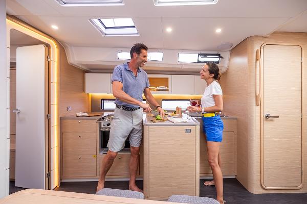 Slide: The Image of Couple enjoying the modern kitchen inside a 2024 Dufour 41 sailboat. - 11