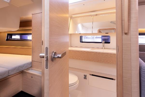 Slide: The Image of Interior of 2024 Dufour 41 yacht featuring bedroom and bathroom with modern design. - 15