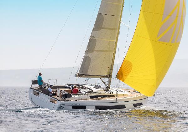 Slide: The Image of 2024 Dufour 41 sailboat with yellow spinnaker sailing on open water. - 6