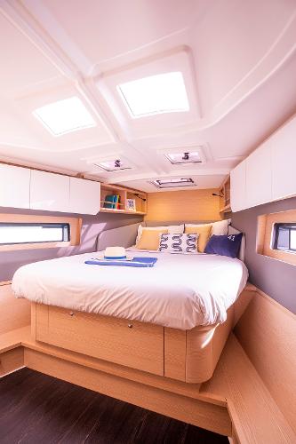 Slide: The Image of Luxurious cabin interior of 2024 Dufour 41 yacht with cozy bed and modern design. - 8