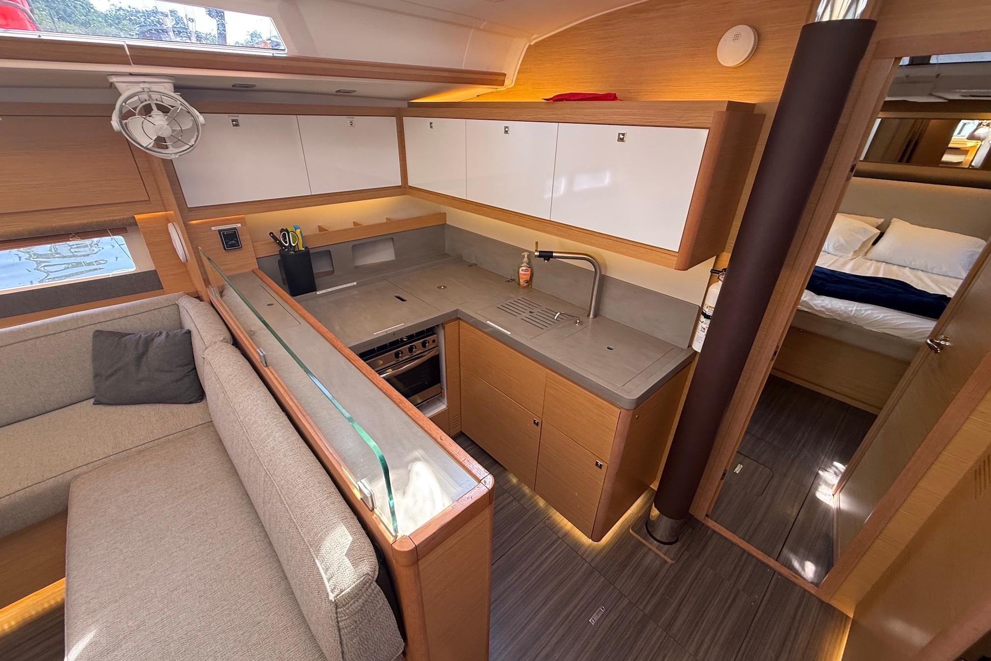 Slide: The Image of Modern kitchen interior of 2022 Dufour 530 yacht with sleek cabinetry and cozy seating area. - 14