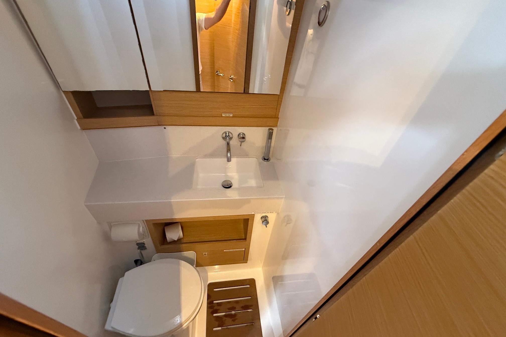 Slide: The Image of Modern bathroom in 2022 Dufour 530 yacht with sink, toilet, and wooden accents. - 23