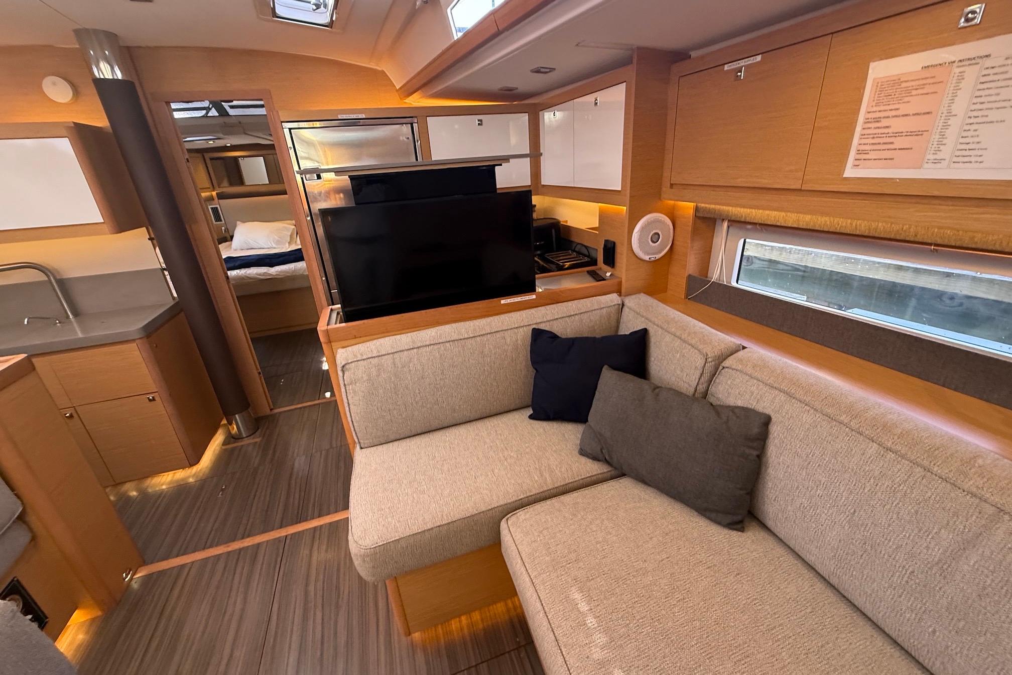 Slide: The Image of Luxurious interior of 2022 Dufour 530 yacht with modern furnishings and cozy seating area. - 31