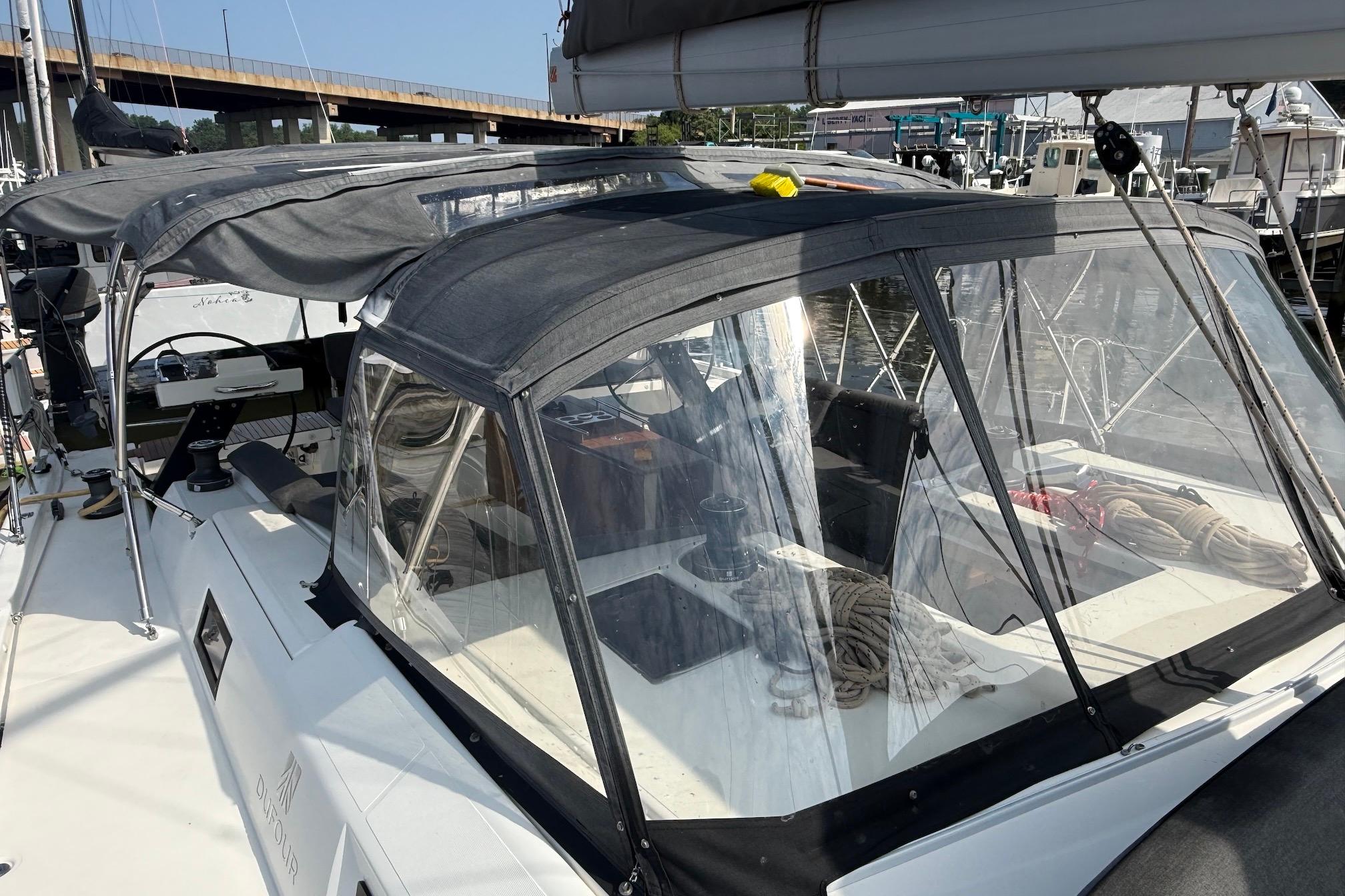 Slide: The Image of 2022 Dufour 530 sailboat with covered cockpit, docked at marina. - 47