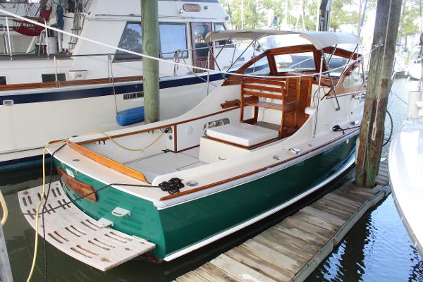 Slide: The Image of 1989 Dyer Downeast boat docked, green hull, white deck, wooden accents. - 0