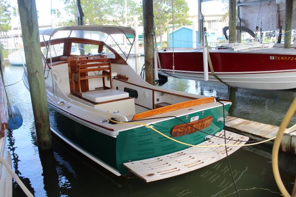 Slide: The Image of 1989 Dyer Downeast boat docked in a marina, rear view. - 2