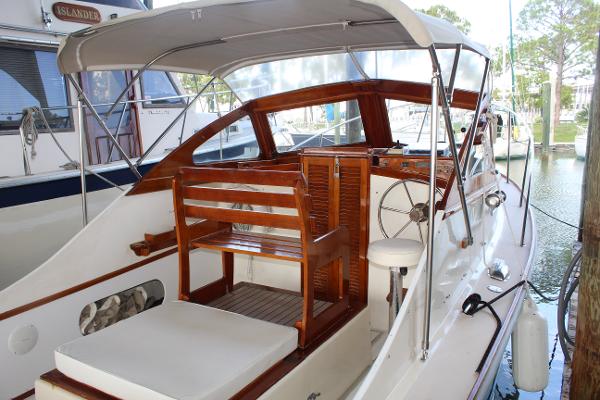 Slide: The Image of 1989 Dyer Downeast boat with wooden interior and canopy docked at marina. - 5