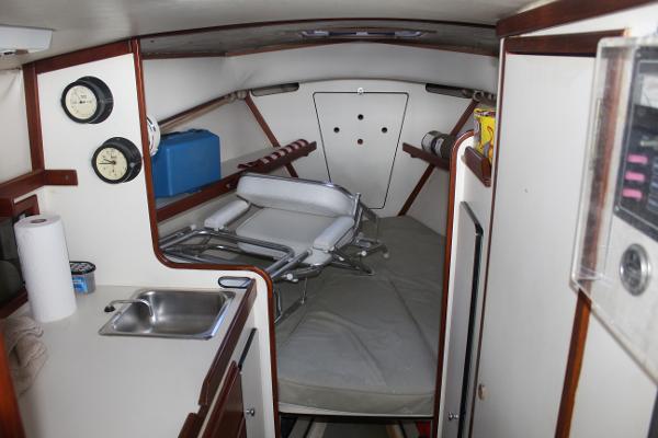 Slide: The Image of 1989 Dyer Downeast boat cabin interior with sink, gauges, and seating. - 8