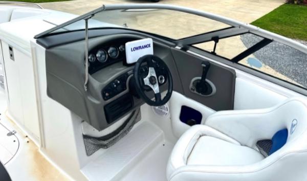 Slide: The Image of 2004 Ebbtide Campione 210 boat cockpit with steering wheel and Lowrance device. - 4