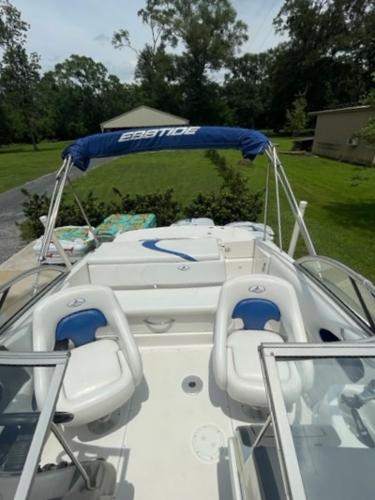 Slide: The Image of 2004 Ebbtide Campione 210 boat with blue and white seating and canopy. - 5