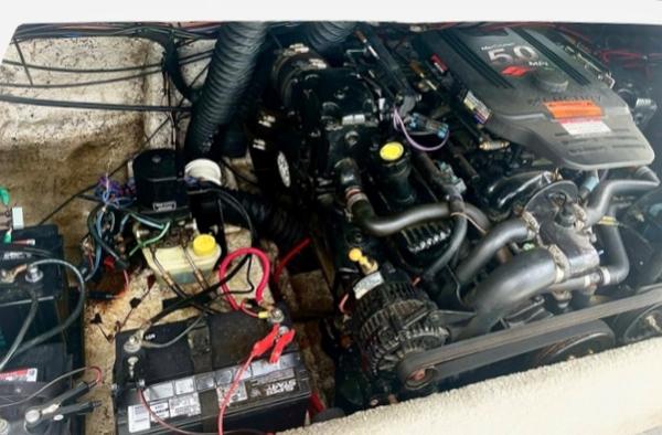 Slide: The Image of 2004 Ebbtide Campione 210 boat engine compartment with batteries and wiring. - 6