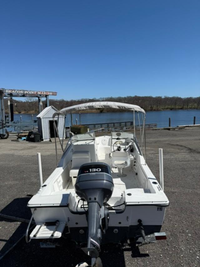 Slide: The Image of 2001 Edgewater 185DC boat at Beacon Point Marine, parked near a scenic waterfront. - 5