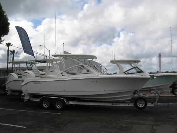 Slide: The Image of 2024 Edgewater 245CX boat on a trailer in a marina parking lot. - 1
