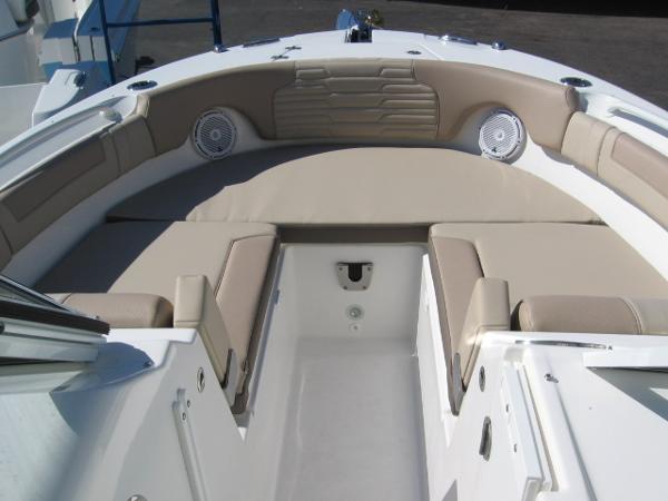 Slide: The Image of 2024 Edgewater 245CX boat with spacious bow seating and beige cushions. - 2