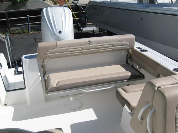 Slide: The Image of 2024 Edgewater 245CX boat interior with beige seating and outboard motor. - 3