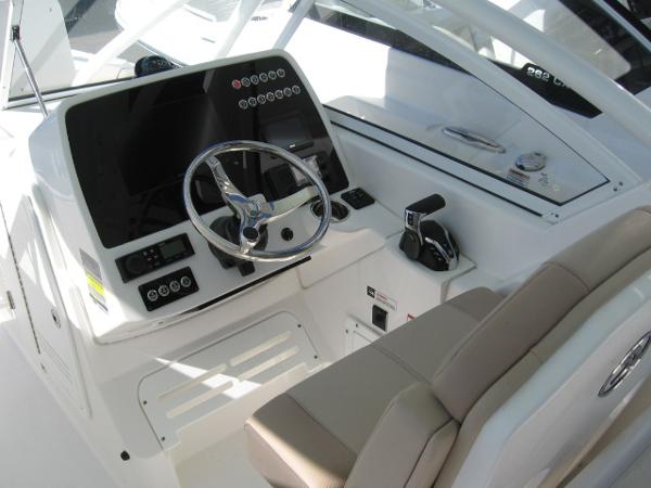 Slide: The Image of 2024 Edgewater 245CX boat cockpit with steering wheel and control panel. - 8