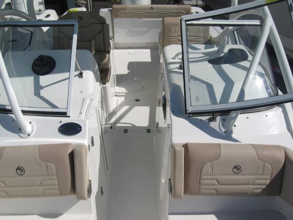 Slide: The Image of 2024 Edgewater 245CX boat interior with open windshield and beige seating. - 9
