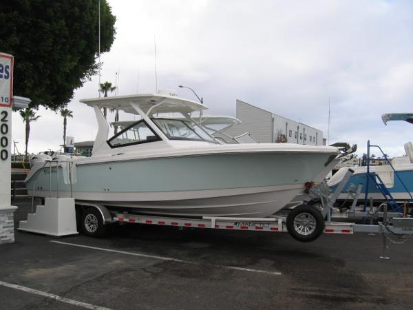 Slide: The Image of 2024 Edgewater 262 CX boat on a trailer in a parking lot. - 1