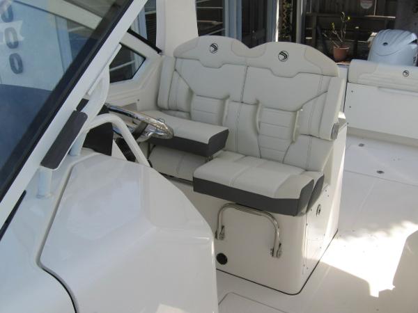 Slide: The Image of 2024 Edgewater 262 CX boat interior with dual seating and steering wheel. - 2