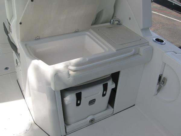 Slide: The Image of 2024 Edgewater 262 CX boat sink and cooler storage area. - 9