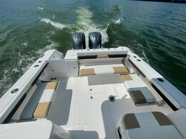 Slide: The Image of 2024 Edgewater 280 CX boat with twin engines cruising on water. - 4