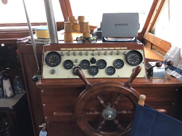 Slide: The Image of 1963 Egg Harbor Convertible Cruiser helm with vintage gauges and wooden steering wheel. - 11
