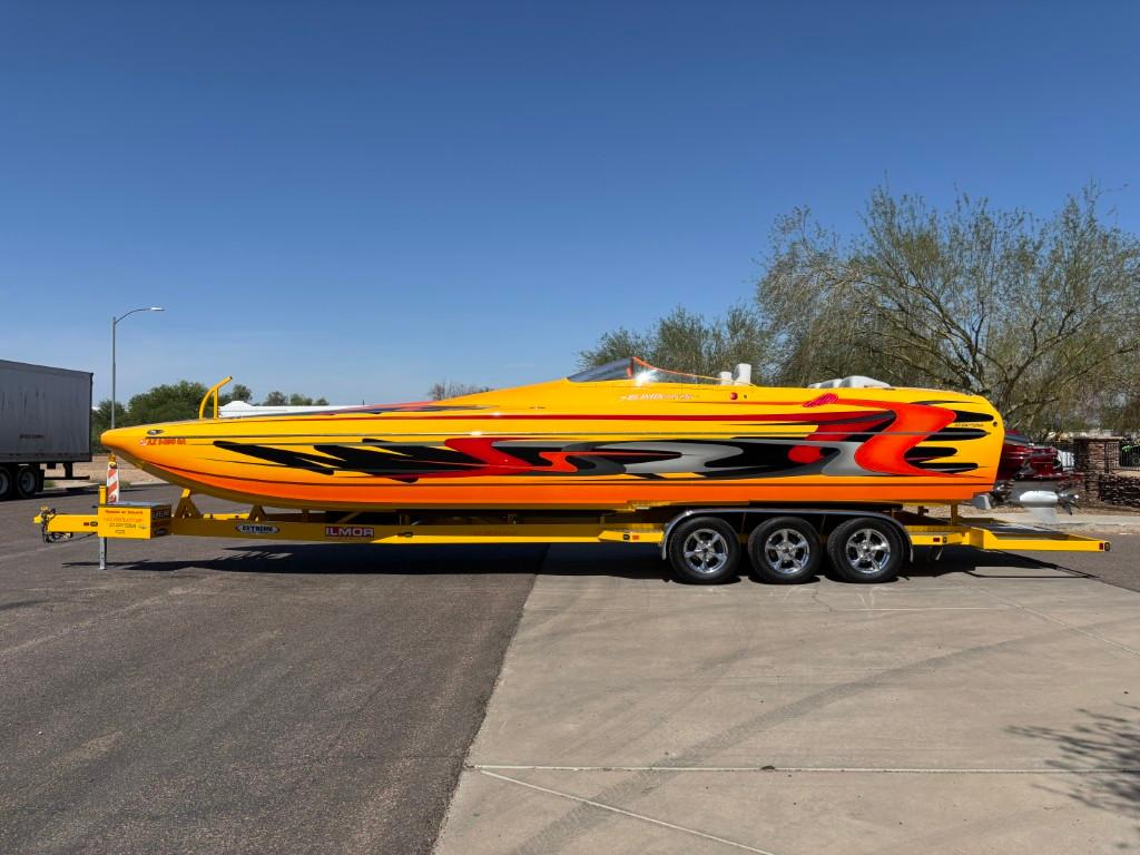 Slide: The Image of 2006 Eliminator 33 Daytona speedboat with vibrant yellow and orange design on a trailer. - 19