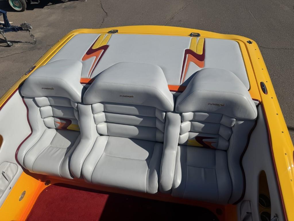 Slide: The Image of 2006 Eliminator 33 Daytona boat interior with white and yellow seats, red carpet. - 39