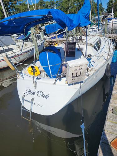 Slide: The Image of 1984 Elite 32 sailboat named Ghost Crab docked at a marina. - 0