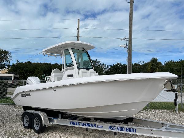 Slide: The Image of 2023 Everglades 235CC boat on trailer, displayed outdoors under cloudy sky. - 0