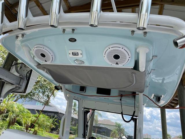 Slide: The Image of 2020 Everglades 255 CC boat with speakers and storage under canopy. - 4
