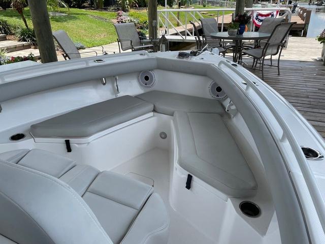 Slide: The Image of 2020 Everglades 255 CC boat interior with cushioned seating and cup holders. - 5