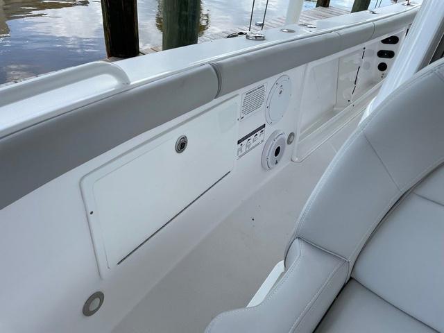 Slide: The Image of 2020 Everglades 255 CC boat interior with white seating and storage compartments. - 9