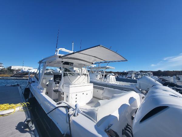 Slide: The Image of 2018 Everglades 360 LXC boat docked at marina under clear blue sky. - 12