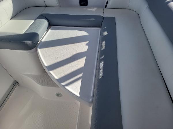 Slide: The Image of 2018 Everglades 360 LXC boat interior seating area with white and gray upholstery. - 16
