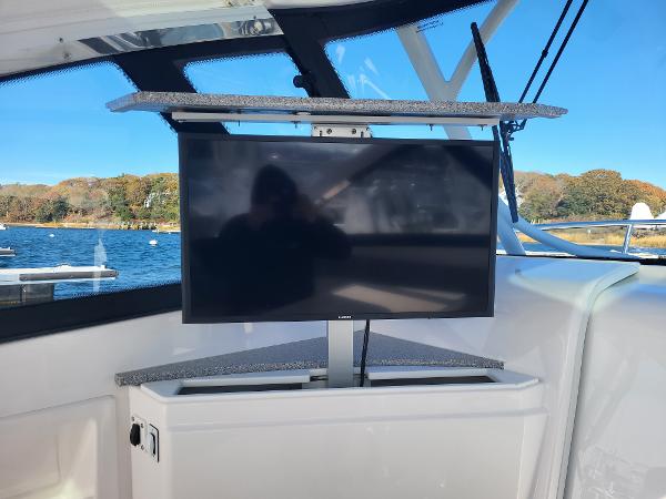 Slide: The Image of Flat-screen TV on 2018 Everglades 360 LXC boat with scenic water view. - 17