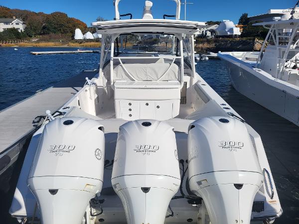 Slide: The Image of 2018 Everglades 360 LXC boat with triple 300 horsepower engines docked. - 2