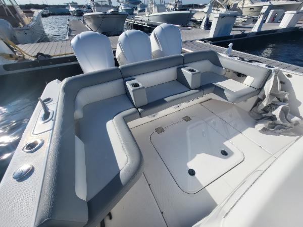 Slide: The Image of 2018 Everglades 360 LXC boat with spacious seating area docked at marina. - 4