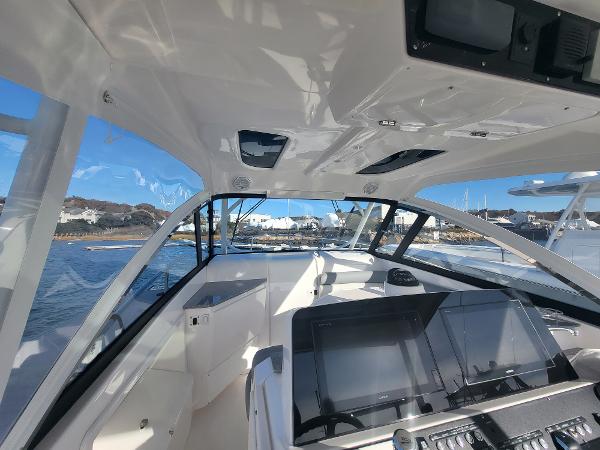 Slide: The Image of Interior view of 2018 Everglades 360 LXC boat with modern dashboard and clear windows. - 42