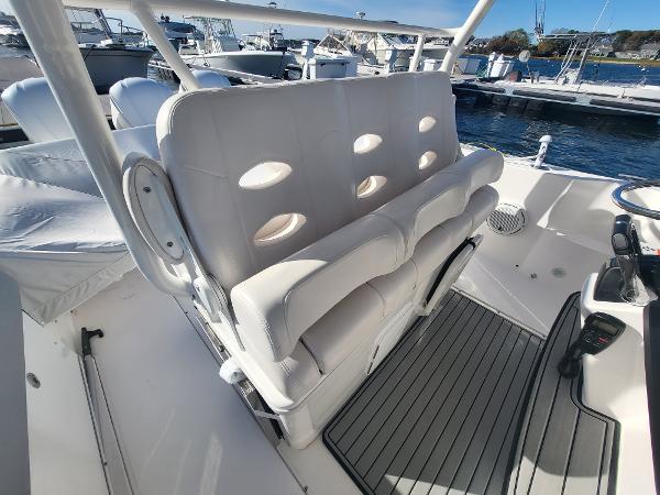 Slide: The Image of 2018 Everglades 360 LXC boat interior with white cushioned seating. - 47