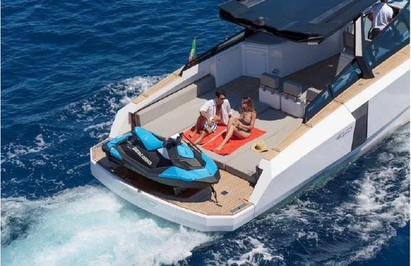 Slide: The Image of 2017 Evo Yachts 43 with jet ski and sunbathing couple on deck. - 3