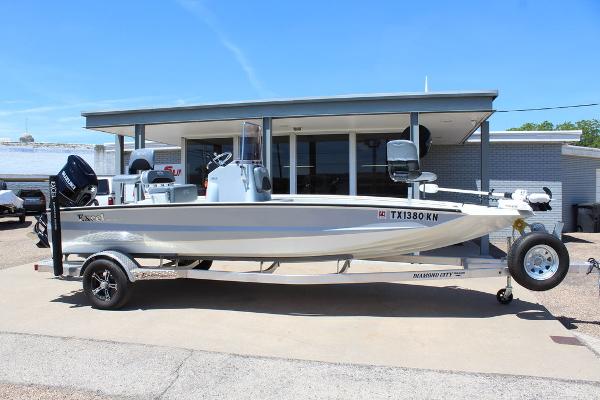Slide: The Image of 2022 Excel Bay Pro 203 boat on a trailer outside a dealership. - 1