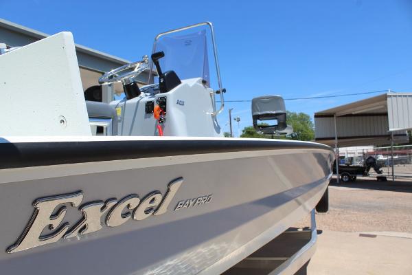 Slide: The Image of 2022 Excel Bay Pro 203 boat side view with logo in a marina. - 18